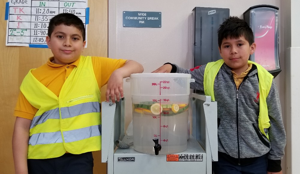 Boys next to water station